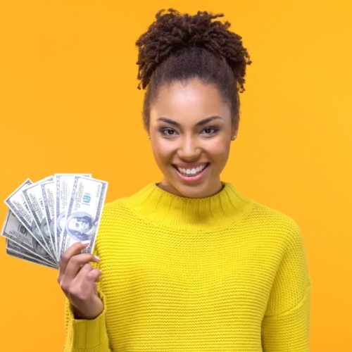 women in yellow holding money